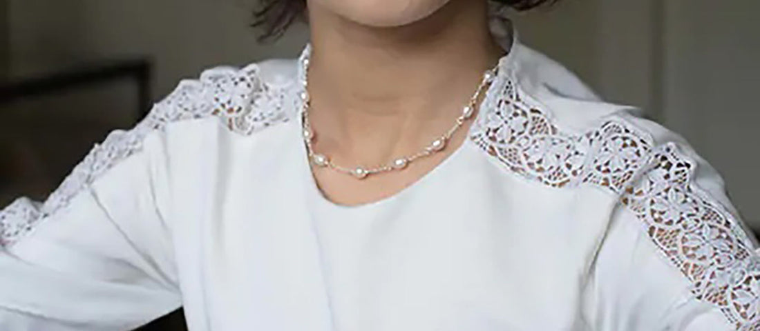 Girl wearing white dress and pearl necklace